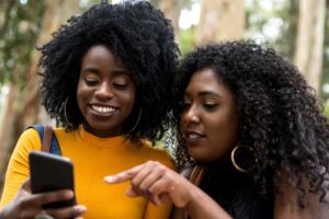 Two women looking at a smartphone screen